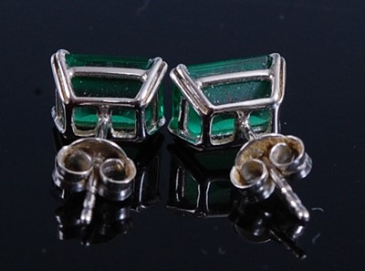 Lot 2188 - A pair of white metal emerald single stone...