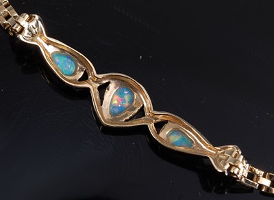 Lot 2169 - A yellow metal opal bracelet, comprising three...