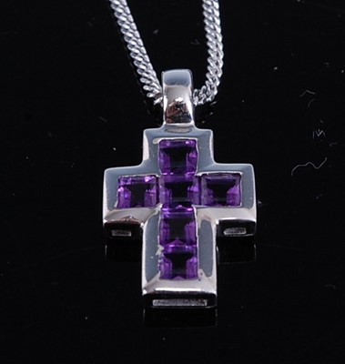 Lot 305 - An 18ct white gold and amethyst cross pendant,...