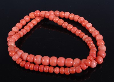 Lot 325 - A beaded coral single string necklace 62cm,...