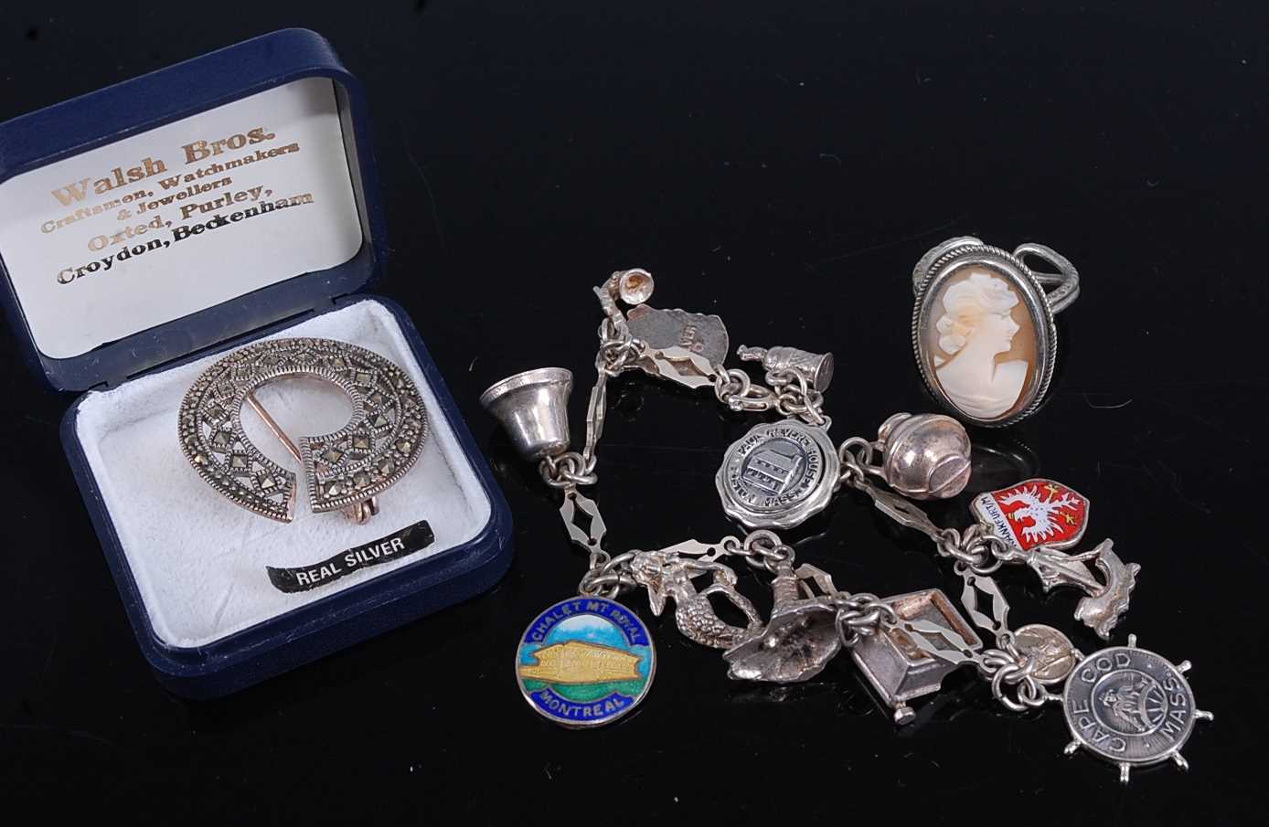 Lot 327 - A silver and white metal charm bracelet...