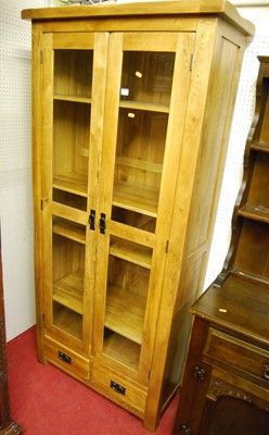 Lot 1114 - A contemporary light oak double door glazed...