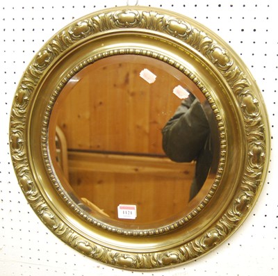 Lot 1121 - A floral embossed brass framed circular...