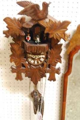 Lot 1126 - A carved and stained softwood cuckoo wall...