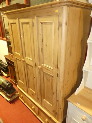 Lot 1133 - A contemporary pine round cornered  three door...