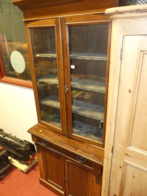 Lot 1134 - A late Victorian walnut bookcase cupboard,...