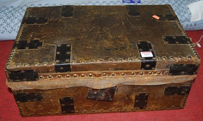 Lot 1097 - A studded leather and metal bound small trunk,...