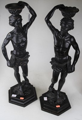 Lot 112 - A large pair of ebonised figures, each carved...