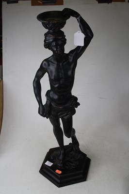Lot 112 - A large pair of ebonised figures, each carved...