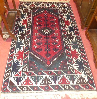 Lot 1140 - A Persian woollen red ground Shiraz rug, 210 x...