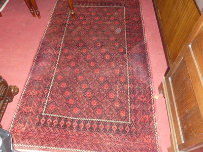 Lot 1141 - A Persian woollen red ground Turkoman rug, 195...