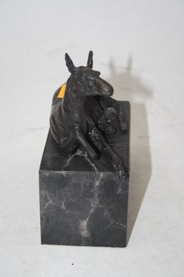 Lot 175 - A bronze model of a recumbent deer on black...