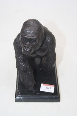 Lot 185 - A bronzed metal gorilla on black hardstone...