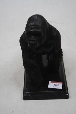 Lot 185 - A bronzed metal gorilla on black hardstone...