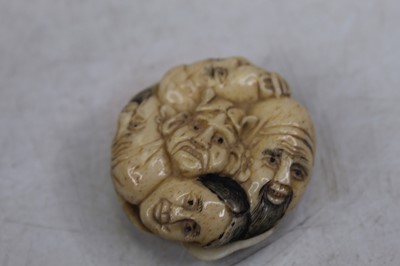 Lot 362 - A reproduction faux ivory netsuke, moulded as...
