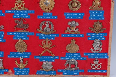 Lot 235 - A collection of cap badges and insignia to...