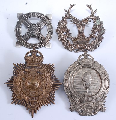 Lot 232 - A collection of cap and glengarry badges to...