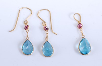 Lot 2186 - A pair of yellow metal, blue topaz and garnet...
