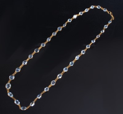 Lot 2194 - A yellow metal aquamarine necklet, featuring...