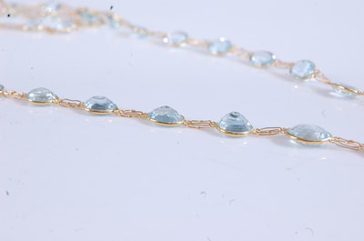 Lot 2194 - A yellow metal aquamarine necklet, featuring...