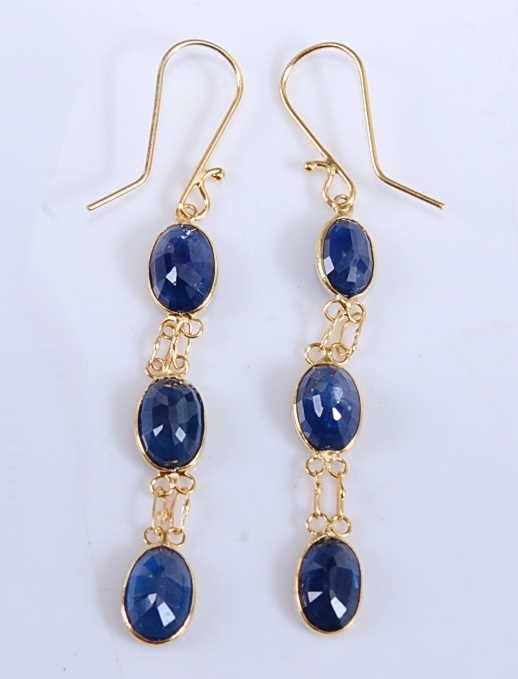 Lot 2502 - A pair of yellow metal sapphire drop earrings,...