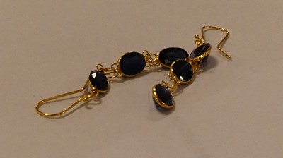 Lot 2502 - A pair of yellow metal sapphire drop earrings,...