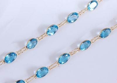 Lot 2506 - A yellow metal blue topaz necklace, comprising...