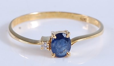 Lot 2512 - A yellow metal, sapphire and diamond two stone...
