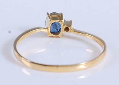 Lot 2512 - A yellow metal, sapphire and diamond two stone...