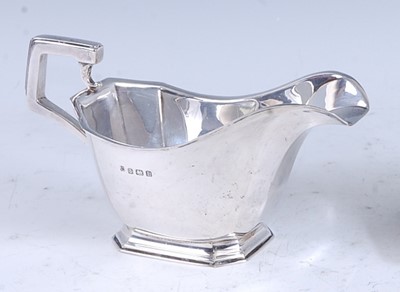 Lot 221 - An Art Deco silver sauceboat, of plain faceted...