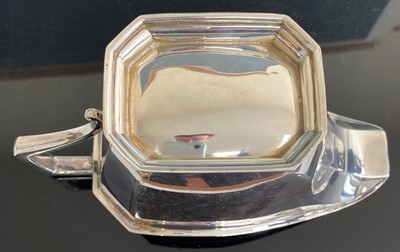 Lot 221 - An Art Deco silver sauceboat, of plain faceted...