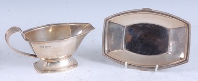 Lot 222 - An Art Deco silver sauceboat on stand, having...