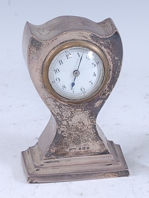 Lot 223 - An Art Nouveau silver clad bedside clock, of...