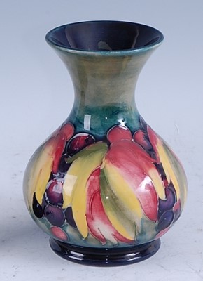 Lot 85 - A Moorcroft pottery squat vase in the Grape &...