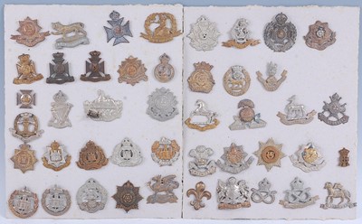 Lot 275 - A collection of cap badges and insignia to...