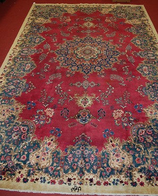 Lot 2444 - A Persian woollen Meshed carpet, the deep red...