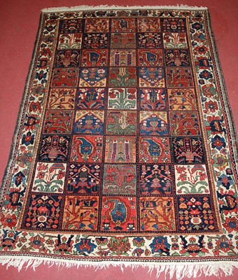 Lot 2449 - A Turkish woollen rug, the ground decorated...