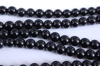 Lot 2520 - A long row of 126 black spherical beads,...