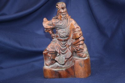 Lot 4 - A 20th century Chinese carved wood figure of a...