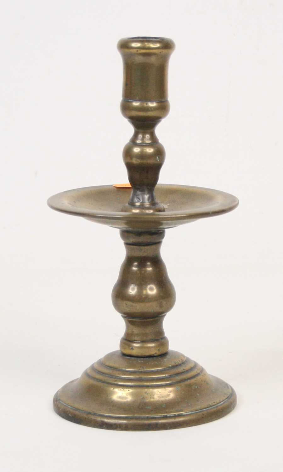 Lot 7 - A 19th century bronze candlestick, standing...