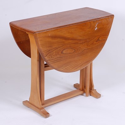 Lot 515 - A 1960s Ercol light elm dropflap breakfast...