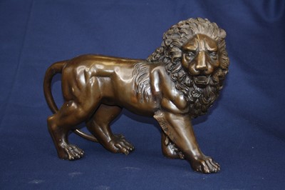 Lot 74 - A pair of bronze models of lions, each in...