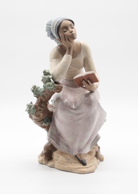 Lot 254 - A Lladro porcelain figure of a seated girl...