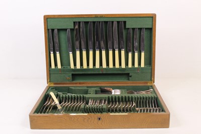 Lot 414 - A 1920s oak cased eight place setting canteen...