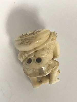 Lot 470 - A Japanese Meiji period ivory netsuke carved...
