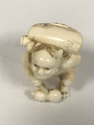 Lot 470 - A Japanese Meiji period ivory netsuke carved...
