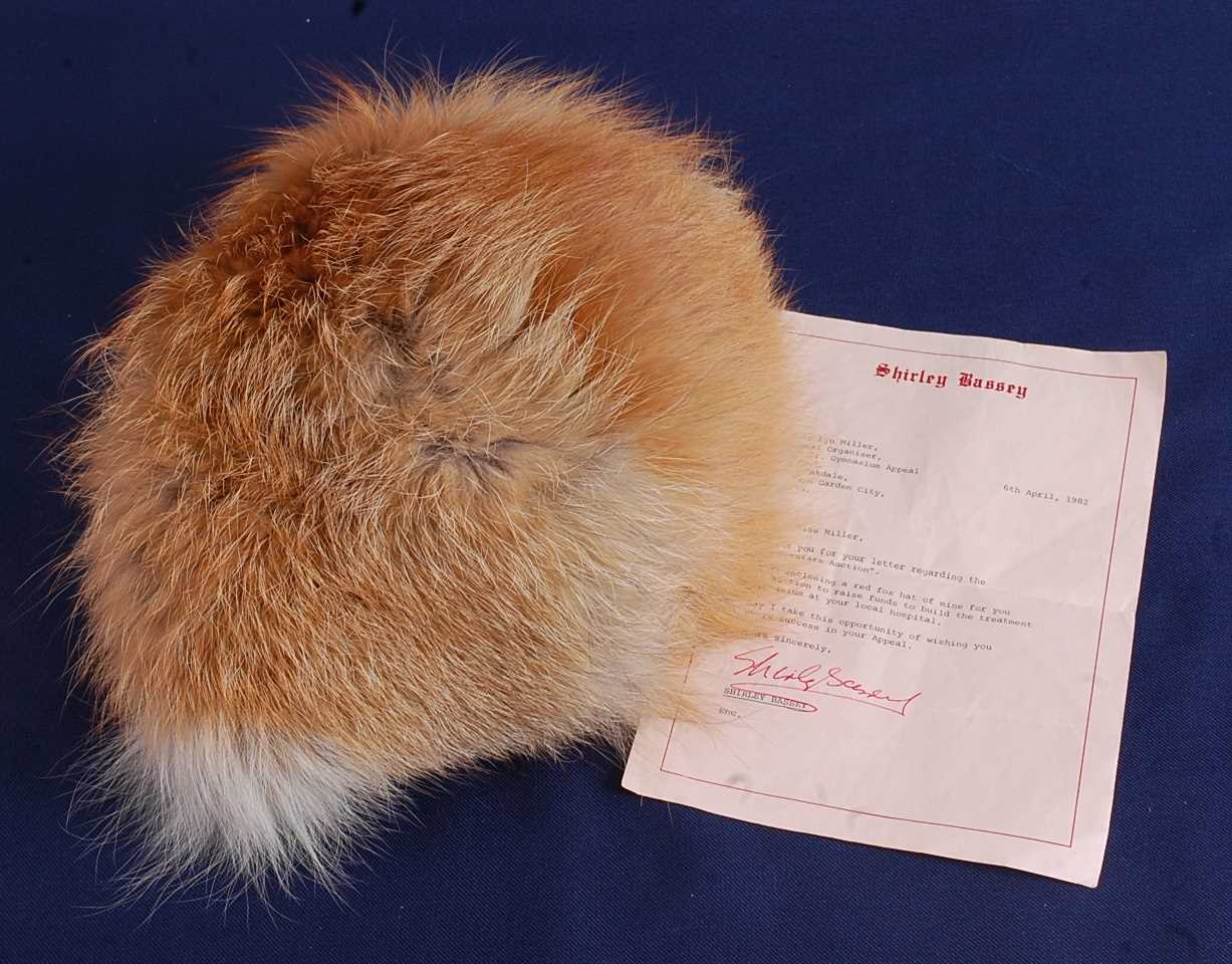 Lot 1137 - Shirley Bassey, a red fox fur hat, bearing a...