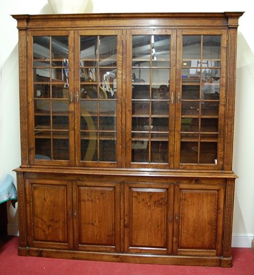 Lot 2475 - An oak four door library bookcase in the...