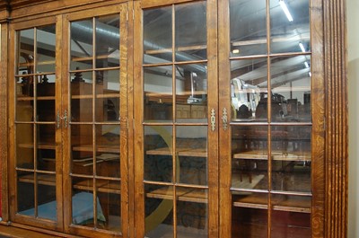 Lot 2475 - An oak four door library bookcase in the...