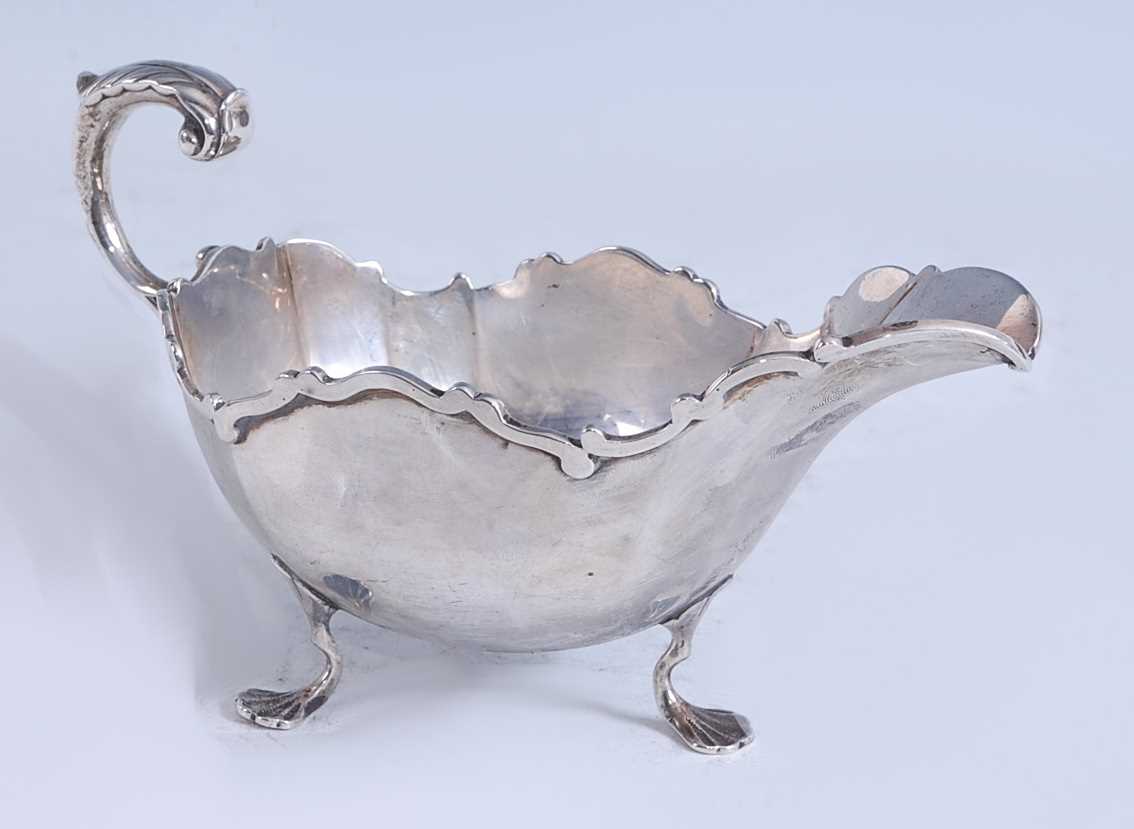 Lot 2147 - A George V silver sauceboat, of slightly lobed...